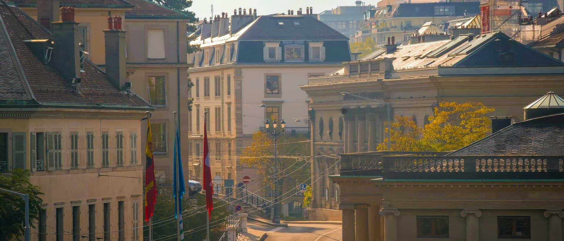 Geneva old-town civic architecture with the cantonal and Swiss flags